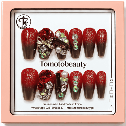 Tomoto Beauty A045 glossy ruby red to black-brown ombre press on nails with gold glitter, red gemstone, pearls, rhinestones and metallic bow details