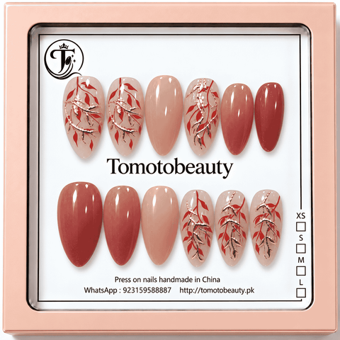 Nude and terracotta red almond press on nails with fine rose gold branches and red leaf botanical designs B002
