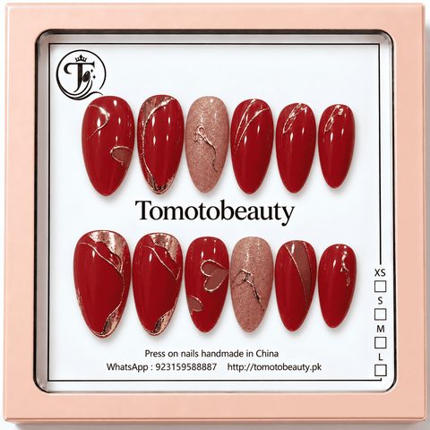 Ruby burgundy red almond press on nails with rose gold swirl linework and sparkling pink accent B003