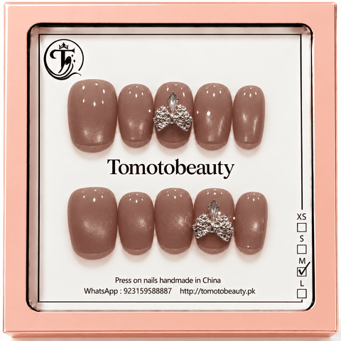 Tomoto Beauty B022: A subtle mocha taupe nude glossy short square nail set accented with a silver crystal bow for an understated elegant look.