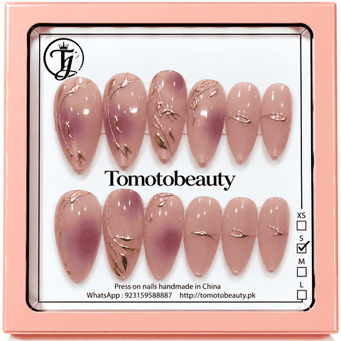 Tomoto Beauty B029: Sheer blush nude almond nails with subtle mauve airbrushed centres and graceful metallic rose gold vine and branch line designs.