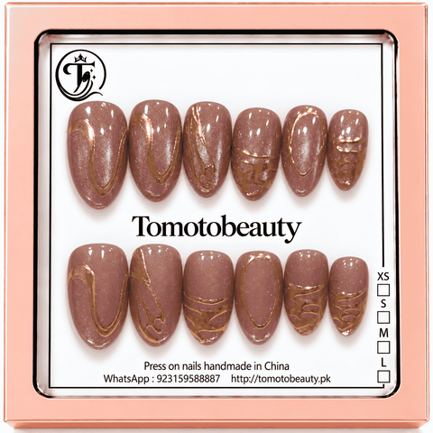 Tomoto Beauty B033: Elegant shimmering mauve-pink almond nails with metallic gold loops, flowing abstract lines and artistic details.