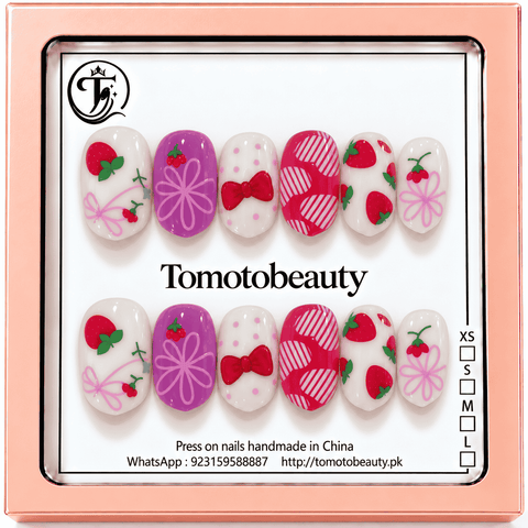 Tomoto Beauty B204 – Strawberry Pink Bow Cartoon Kids Press On Nails. Cute mixed white, purple and pink cartoon nail art featuring strawberries, cherries, pink ribbon bows and dots.