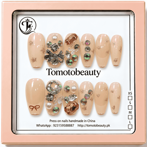 Tomoto Beauty A001 nude peach press on nails with rose gold glitter, crystal rhinestones, pearl embellishments and silver bow, 12-piece set
