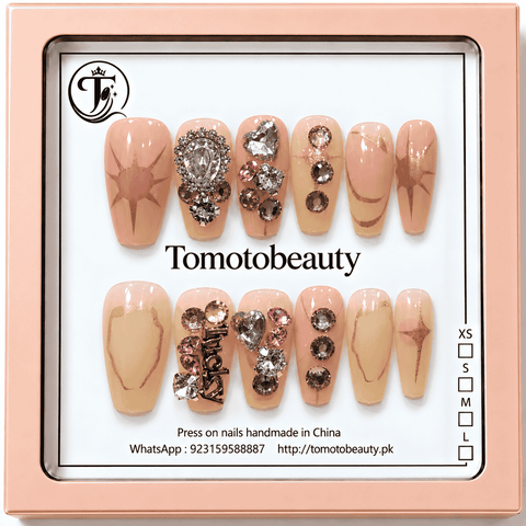 Tomoto Beauty A007 blush pink and nude press on nails with rose gold starburst design, clear heart crystals and rhinestone decorations, 12 nails