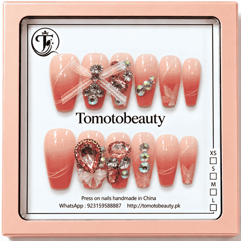 Tomoto Beauty A009 coral pink ombre press on nails with white ribbon bow details, clear and rose pink rhinestone gems and delicate floral line art, 12 nails