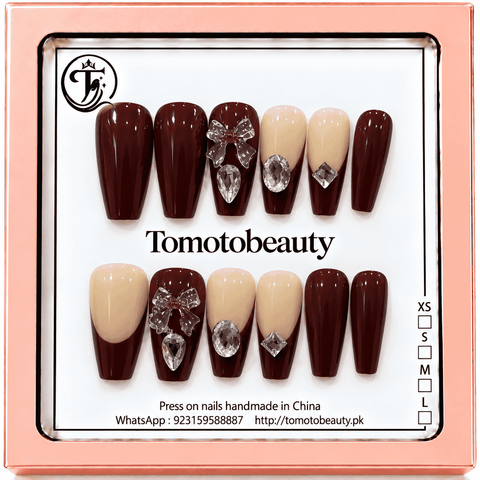 Tomoto Beauty C102 – Burgundy Crystal Bow Coffin Press On Nails. Deep burgundy and nude French-style coffin nails with clear crystal bows, teardrop gems and geometric rhinestone accents.