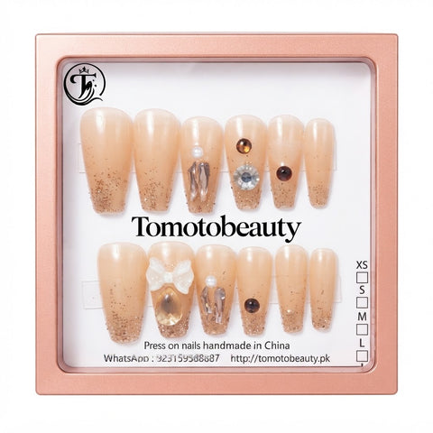 Tomoto Beauty C110 – Ivory Gold Crystal Rhinestone Press On Nails. Soft ivory champagne nails with statement clear crystals, gold-toned stone detailing, sparkles and a white bow accent.