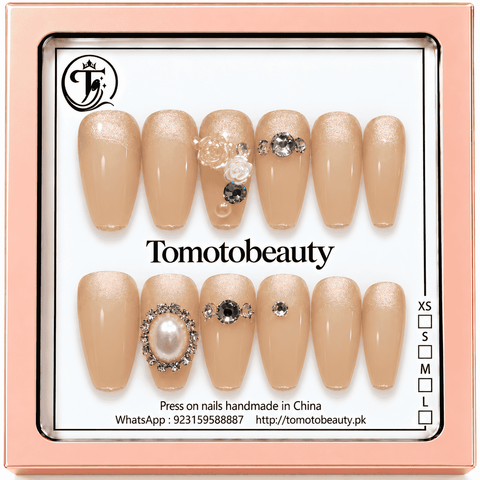 Tomoto Beauty C201 – Champagne Rose Pearl Crystal Press On Nails. Delicate champagne peach nails with soft gold shimmer, sculpted white flowers, pearl accents and sparkling clear crystal clusters.